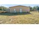 Tan metal barn with two doors; additional fenced area at 4248 Ne 175Th Street Rd, Citra, FL 32113