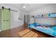 ' bedroom with bunk beds and a barn door at 4248 Ne 175Th Street Rd, Citra, FL 32113