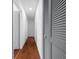 Clean hallway with hardwood floors and gray louvered doors at 4248 Ne 175Th Street Rd, Citra, FL 32113