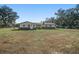 Ranch-style home with white exterior and grey accents, nestled in a green landscape at 4248 Ne 175Th Street Rd, Citra, FL 32113