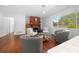 Living area with hardwood floors, fireplace, comfortable seating, and large window at 4248 Ne 175Th Street Rd, Citra, FL 32113
