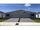 Charming home featuring a paved driveway and a well-maintained lawn and an attached two car garage at 4736 Nw 39Th Street Rd, Ocala, FL 34482