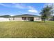 Large backyard with a covered patio and a tree providing shade at 5826 Sw 83Rd Ln, Ocala, FL 34476