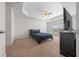 Spacious bedroom with a ceiling fan and large TV at 5826 Sw 83Rd Ln, Ocala, FL 34476