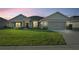 One-story home with stone accents, two-car garage, and manicured lawn at 5826 Sw 83Rd Ln, Ocala, FL 34476