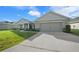 One-story home with a two-car garage, stone accents, and a landscaped front yard at 5826 Sw 83Rd Ln, Ocala, FL 34476
