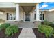 Covered front porch with stone columns and a double front door at 5826 Sw 83Rd Ln, Ocala, FL 34476