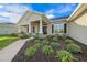 Landscaped front yard with a walkway leading to the house entrance at 5826 Sw 83Rd Ln, Ocala, FL 34476