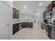 Open concept kitchen with dark wood cabinets and tile floors at 5826 Sw 83Rd Ln, Ocala, FL 34476