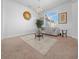 Bright living room with large windows and chandelier at 5826 Sw 83Rd Ln, Ocala, FL 34476