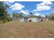 House with covered patio, spacious backyard, and mature trees at 6 Bahia Course Way, Ocala, FL 34472