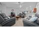 Bright living room with comfortable reclining sofas and a flat-screen TV at 6 Bahia Course Way, Ocala, FL 34472