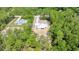 Aerial view of a home under construction on a treed lot with a long driveway at 6877 Sw 131St Cir, Ocala, FL 34481