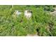 A high aerial shot shows a new home under construction amidst a dense canopy of trees at 6877 Sw 131St Cir, Ocala, FL 34481