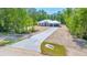 An aerial view shows the home's long driveway with decorative green spaces along the edge of the yard at 6877 Sw 131St Cir, Ocala, FL 34481