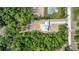 Overhead view showcasing the white roof and surrounding lush greenery at 6877 Sw 131St Cir, Ocala, FL 34481