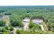 Aerial view of new construction home and treed lot with long driveway at 6877 Sw 131St Cir, Ocala, FL 34481