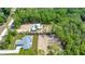 Aerial view of new homes surrounded by lush, mature trees in a rural setting at 6877 Sw 131St Cir, Ocala, FL 34481