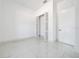 Modern bedroom with white walls, a closet, and bright tile flooring at 6877 Sw 131St Cir, Ocala, FL 34481