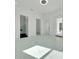Bright bedroom with modern floors and multiple doorways leading to other areas of the home at 6877 Sw 131St Cir, Ocala, FL 34481