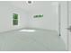 Bright bedroom with modern tiled floors and natural light from two windows at 6877 Sw 131St Cir, Ocala, FL 34481