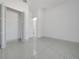 Bright bedroom features a closet, tile flooring, and white walls for a clean, modern look at 6877 Sw 131St Cir, Ocala, FL 34481