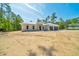 Single Gathering home with contrasting garage doors, minimal landscaping, and long driveway at 6877 Sw 131St Cir, Ocala, FL 34481