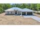 New home with metal roof, clean lines, and modern garage doors at 6877 Sw 131St Cir, Ocala, FL 34481