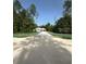 Inviting single story home boasts an attached two car garage and a long drive in a wooded lot at 6877 Sw 131St Cir, Ocala, FL 34481
