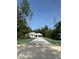 Inviting single story home boasts an attached two car garage and a long drive in a wooded lot at 6877 Sw 131St Cir, Ocala, FL 34481