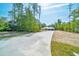 Home's front exterior showcasing driveway and landscaping potential at 6877 Sw 131St Cir, Ocala, FL 34481