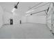 Clean and organized garage space with an insulated door and plenty of room for vehicles and storage at 6877 Sw 131St Cir, Ocala, FL 34481