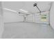 Spacious garage with high ceilings and insulated doors, offering plenty of storage at 6877 Sw 131St Cir, Ocala, FL 34481