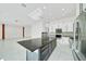Contemporary kitchen boasts stainless steel appliances and stylish white and gray cabinetry at 6877 Sw 131St Cir, Ocala, FL 34481