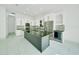 Stylish kitchen boasts stainless steel appliances, quartz countertops, a wine cooler, and a large island with bar seating at 6877 Sw 131St Cir, Ocala, FL 34481