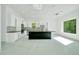 Modern kitchen featuring white cabinets, a large black island, stainless steel appliances, and bright natural lighting at 6877 Sw 131St Cir, Ocala, FL 34481