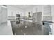 Spacious kitchen featuring an oversized island with cooktop, stainless steel appliances, and white cabinetry at 6877 Sw 131St Cir, Ocala, FL 34481