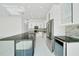 Modern kitchen with stainless steel appliances, beautiful countertops, a large island, and sleek white cabinetry at 6877 Sw 131St Cir, Ocala, FL 34481