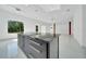 Modern kitchen featuring a large island with stone countertops and bright, open space at 6877 Sw 131St Cir, Ocala, FL 34481
