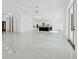 Spacious living room boasts modern lighting, gleaming tile floors, and access to the kitchen with state-of-the-art appliances at 6877 Sw 131St Cir, Ocala, FL 34481