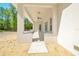 Covered patio featuring neutral tones, outdoor lighting, and serene natural surroundings at 6877 Sw 131St Cir, Ocala, FL 34481