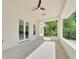 Covered patio with ceiling fan and views of the lush backyard at 6877 Sw 131St Cir, Ocala, FL 34481