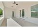 Covered patio featuring neutral tones, outdoor lighting, and serene natural view at 6877 Sw 131St Cir, Ocala, FL 34481