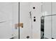 Modern bathroom shower featuring a frameless glass enclosure, a seat, and matte black fixtures at 6877 Sw 131St Cir, Ocala, FL 34481