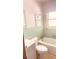 The mint green bathroom offers a shower-tub combo, a tiled backsplash, and well-lit mirror at 691 Se 19Th St, Ocala, FL 34471