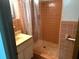 Cozy bathroom featuring a tiled shower and classic peach fixtures at 691 Se 19Th St, Ocala, FL 34471