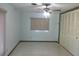 Cozy bedroom featuring natural light, a ceiling fan, and spacious closet at 691 Se 19Th St, Ocala, FL 34471