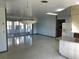 Spacious open-plan kitchen, featuring granite counters and modern appliances, flows into an airy living space at 691 Se 19Th St, Ocala, FL 34471