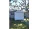 A practical white shed provides secure storage in the backyard, blending with the home's aesthetic at 691 Se 19Th St, Ocala, FL 34471