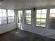 Bright sunroom with large windows offering serene views, perfect for relaxation and enjoying the outdoors at 691 Se 19Th St, Ocala, FL 34471